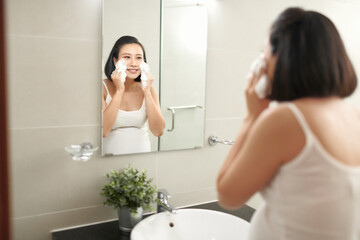 f beautiful pregnant woman washing her face in bathroom