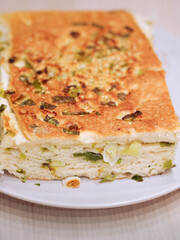 Close up of vegan halal food known as sesame scallion bread or pancake, a popular staple in Northern Asia. The bread is stuffed with spring onions and topped with sesame.