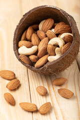 Mix nuts on rustic wood background. Cashew, almonds close up. Healthy food and snack