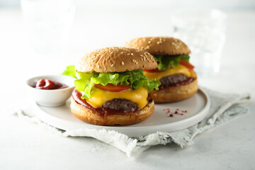 Traditional homemade cheeseburgers on a white plate