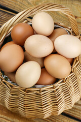 straw basket with eggs on wooden background. High quality photo