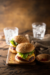 Traditional homemade cheeseburgers on a white plate