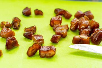 dried fruit date with knife cut small on green