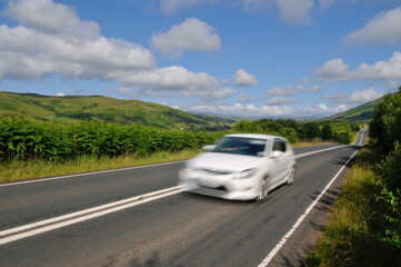 Obraz na płótnie Canvas White car on Scottish road