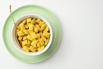 cornflakes and muesli in a green plate on a table