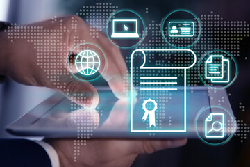 Online learning concept. Diploma with other icons on foreground and man using tablet, closeup