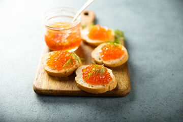 Naklejka na ściany i meble Red caviar on toast with dill