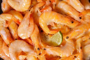 big raw tiger prawns roasted with lemon. close up selective focus