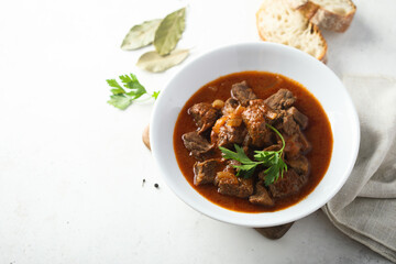 Traditional homemade beef goulash with fresh parsley