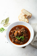 Traditional homemade beef goulash with fresh parsley