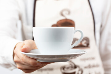 coffee time. A waiter holding and serving a glass of hot coffee, isolated in white background.
