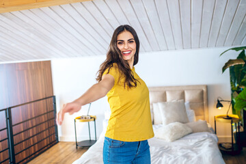 Long-haired beautiful young woman having good time at home