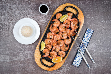 Grilled tiger shrimps with spices, lime and lemon, rice and soy sauce. Prawns fried with herbs....