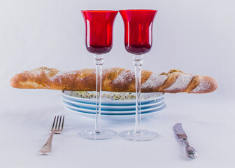 Simple food at home. Celebrate Valentine's day. Table served for two. Wine and bread.