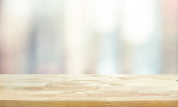 Wood table top on blur window glass,wall background