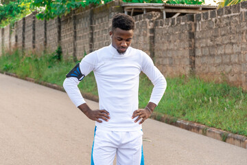 portrait of a young african man listening to music before exercising to help him focus