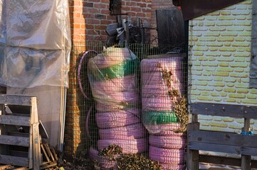 Pink colored car tires stacked in an old abandoned building (Pesaro, Italy, Europe)