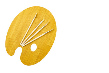 Wooden palette and paintbrushes isolated on white background with copy space.