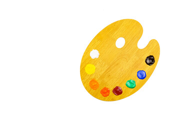 Palette with paints and brushes on a white background