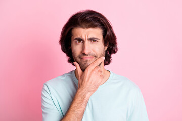 Portrait of intelligent handsome person arm on chin thinking dream wear light blue isolated on pink...