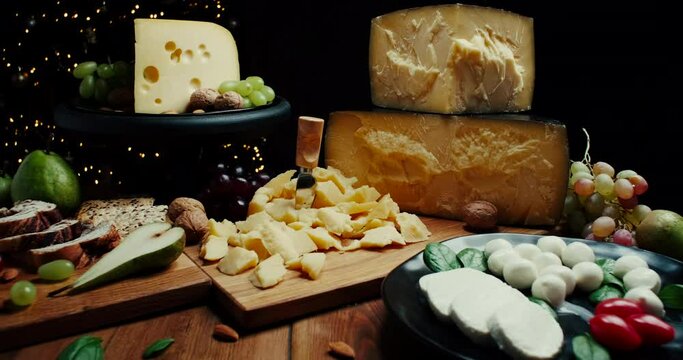 Assortment of different cheese types on wooden background. Cheese background. Slide shot.