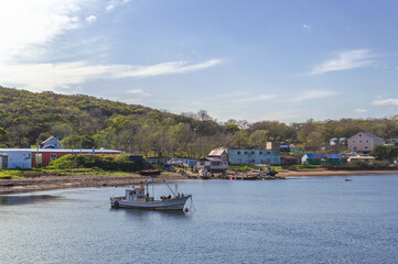 Fototapeta na wymiar moored boat near village on Popovs island