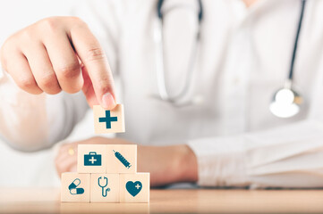 Hand arranging wood block stacking with the healthcare medical icon. Health insurance - health...