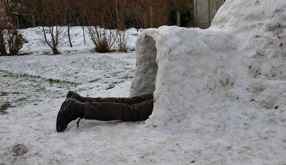 preparation for the polar expedition, sleeping and survival in the igloo. The man is lying in a...