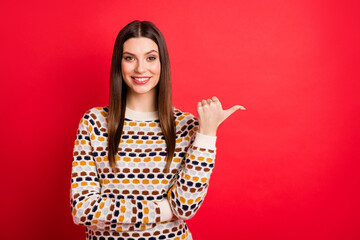 Photo portrait of cheerful girl showing thumb empty space smiling isolated vivid red color background