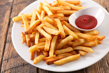 plate with french fries and ketchup