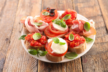 set of canape- bruschettas with tomato, basil, mozzarella
