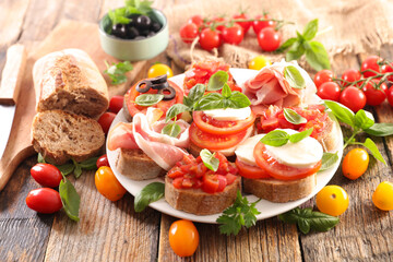 set of canape- bruschettas with tomato, basil, mozzarella