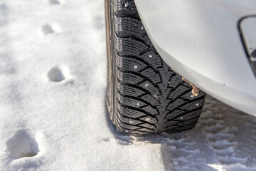 Close-up of car tires in winter on snow-covered road