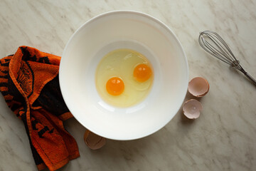Raw eggs in a bowl for making an omelet or dough, top view