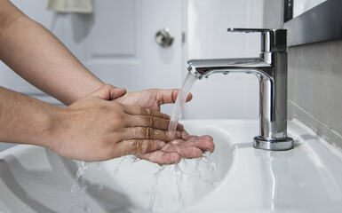 Men are washing their hands in the sinks to clear respiratory bacteria and viruses, sanitation and reduce the spread of COVID-19 that is spread around the world, Hygiene ,Sanitation concept.