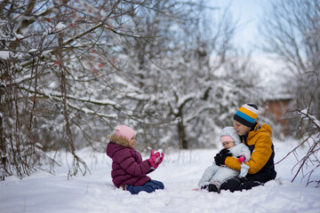 Three children on a walk in winter, a teenager