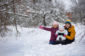 Fototapeta na wymiar Three children on a walk in winter, a teenager