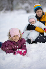 Fototapeta na wymiar Three children on a walk in winter, a teenager