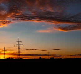 Beautiful summer sunset with high voltage overhead lines near Aholming, Bavaria, Germany