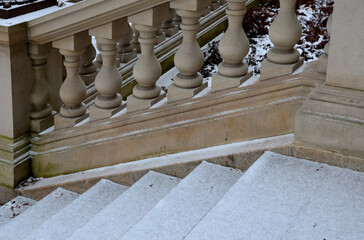 snowy benches near the retaining wall, concrete gray in the park. balustrades and magnificent...