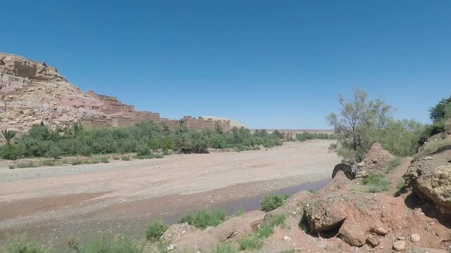 Pan shot of Ait Benhaddou from the bridge on a sunny summer day