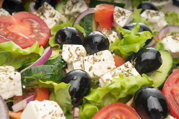Delicious greek salad on a platter macro frame, close up