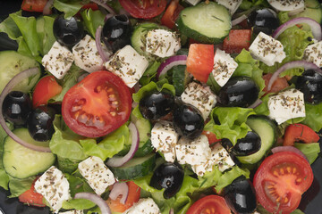 Delicious greek salad on a platter macro frame, close up