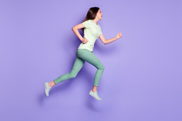 Fototapeta na wymiar Photo portrait full body view of woman running forward jumping up isolated on vivid violet colored background