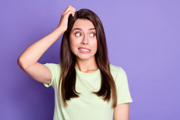 Photo portrait of unsure doubted girl stressed looking at blank space isolated on vibrant purple...