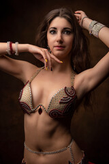 Portrait of a young woman in oriental costume. Belly dance. Oriental dance. The brunette.