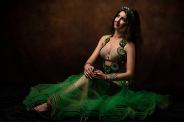 A young woman in an oriental suit. Scheherazade's fairy tale. The brunette. Green.
