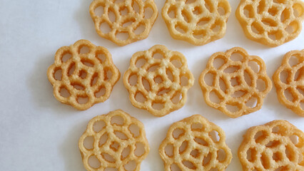 Top view of nicely arranged honeycomb cookies, called kuih loyang in Malaysia, a popular deep-fried snack during festivals. It originates from India and can also be found in Singapore and Indonesia.