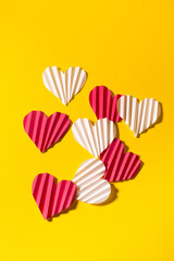 Valentine's day flat lay with copy space. Pink and white hearts on the yellow background. Image for greeting cards. Valentine's day concept