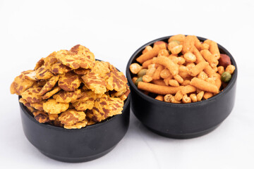 Black Bowl Full Of Spicy Salty Indian Junk Street Food Snacks Chatpata Chana Jor Garam And Daal Boot Mixture In Blur Mostly Enjoyed All Over India Isolated On White Background And Blank Space For Text